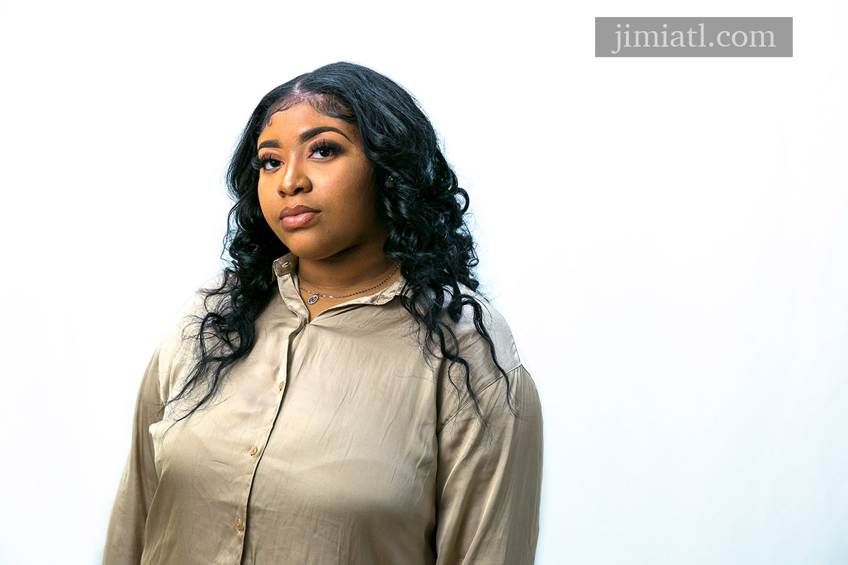 Woman looks straight ahead during headshot photography session.