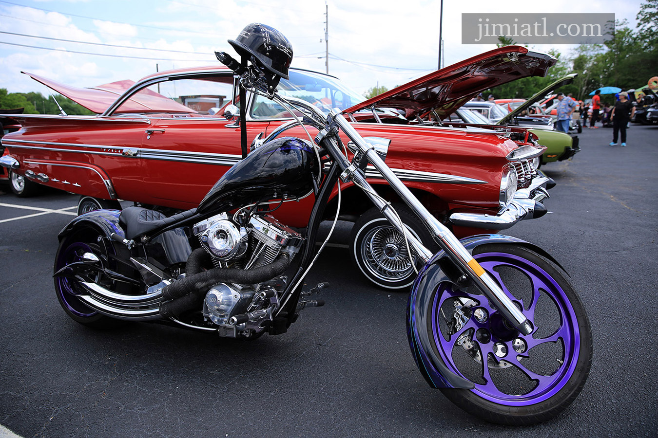 Chevy Impala sitting on rims and motorcycle at car show in Downtown Lawrenceville